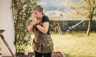 Woman blowing her nose while gardening